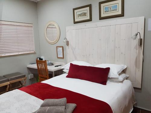 Dormio Manor Guest Lodge tesisinde bir odada yatak veya yataklar