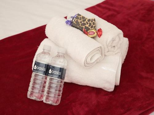 two bottles of water sitting on top of towels at Alucarni Guest House with solar energy in Upington