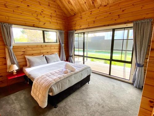 a bedroom with a bed and a large window at Lockwood on Aorangi in Lake Tekapo