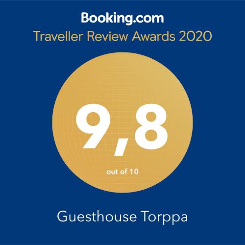 a yellow circle with the text travelling review awards at Guesthouse Torppa in Korkeakoski