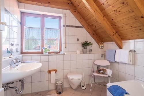 a bathroom with a sink and a toilet at Haus Desor in Kressbronn am Bodensee