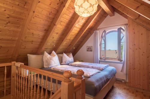 a bedroom with a bed in a wooden house at Haus Desor in Kressbronn am Bodensee