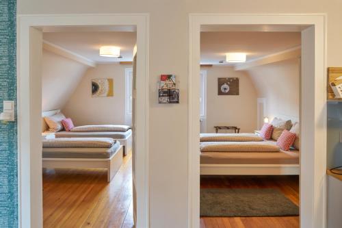 a room with two beds and a living room at Pension Amthof in Oberderdingen