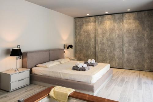 a bedroom with a bed and a large wall at Luxury Beachfront Villa Selenia Platinum in Sounio in Sounio