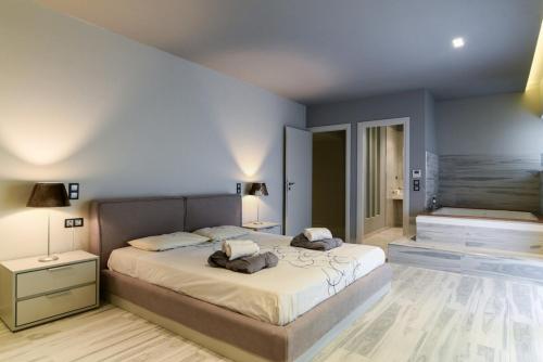 a bedroom with a large bed with two pillows at Luxury Beachfront Villa Selenia Platinum in Sounio in Sounio