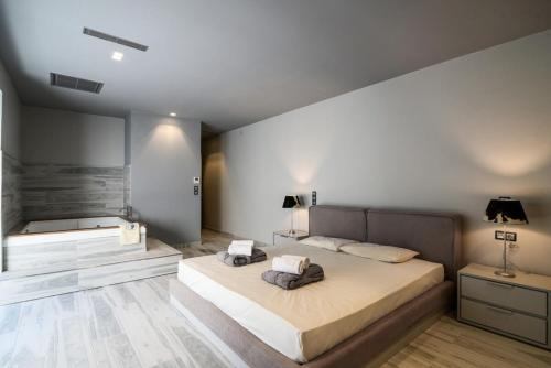 a bedroom with a large bed in a room at Luxury Beachfront Villa Selenia Platinum in Sounio in Sounio