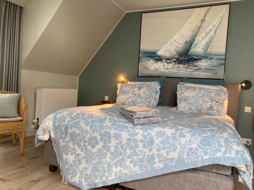 a bedroom with a bed with a sail on the wall at B&B Waterput 1 in Stalhille