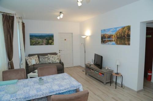 a living room with a table and a couch at Casa Tinkerbell in Sovata