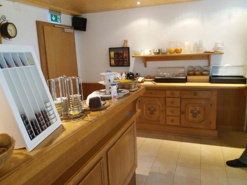 a kitchen with a wooden counter top and a counter sidx sidx at Pension Alpengruss in Heiterwang