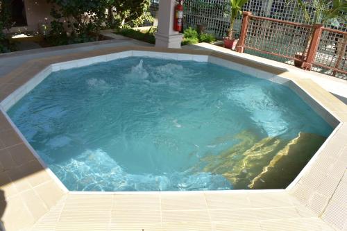 a large swimming pool with blue water at Ramada Plaza by Wyndham Karachi Airport Hotel in Karachi