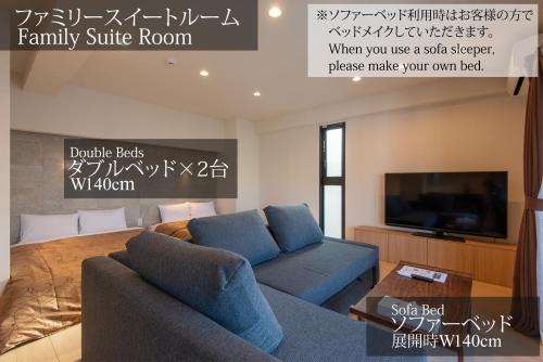 a living room with a couch and a tv at MK Hotels Nishinakasu in Fukuoka