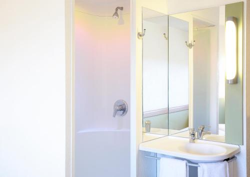 a bathroom with a sink and a mirror at ibis budget Birmingham Centre in Birmingham