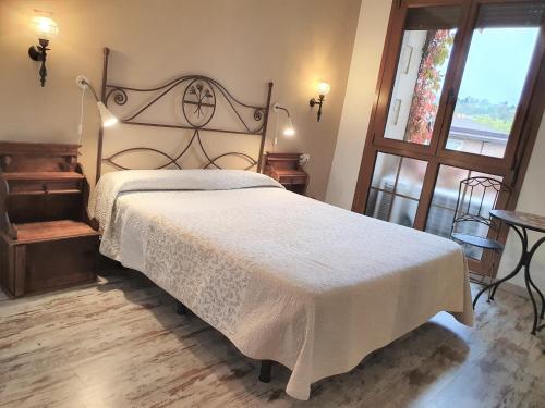 
a bedroom with a bed and a dresser at Los Acebos Arriondas in Arriondas
