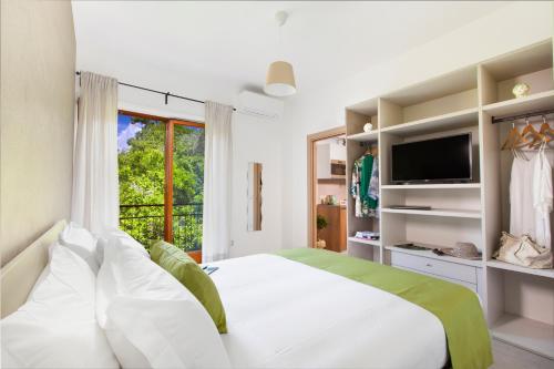 a bedroom with a large bed and a television at Torna a Surriento Suites in Sorrento