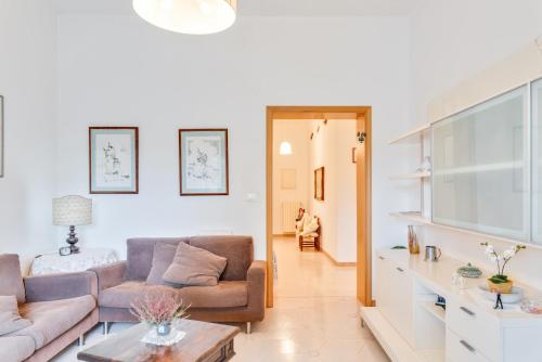 a living room with two couches and a table at Marradi Apartment with Balcony in Livorno