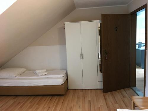 a bedroom with a bed and a closet at Pension Alis Augsburg in Augsburg