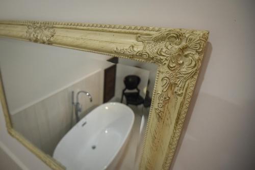 a mirror in a bathroom with a sink at Villa Campana in Siófok