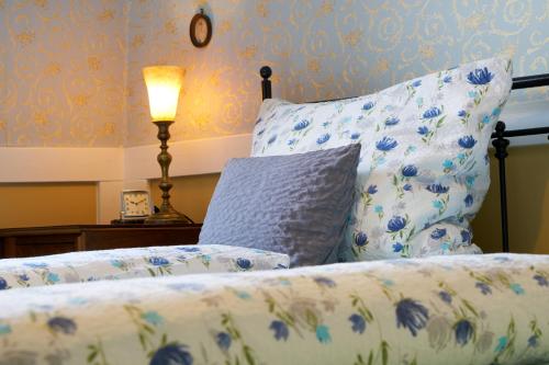 a bedroom with a bed with a pillow and a lamp at Pension Amthof in Oberderdingen