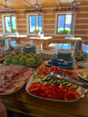a wooden table with plates of food on it at Hotel Hvezda in Pec pod Sněžkou