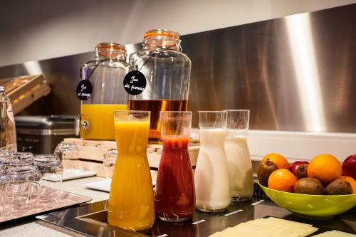 a bunch of different types of drinks on a counter at ibis Birmingham Airport Terminal Building - NEC in Bickenhill
