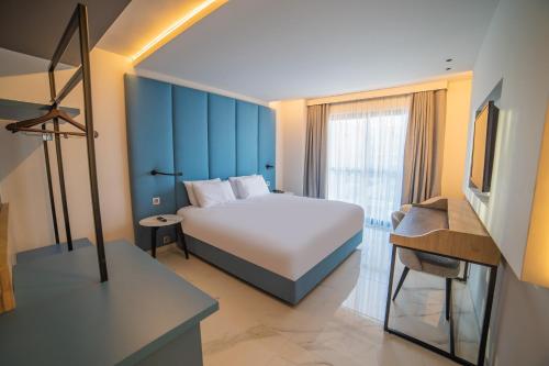 a bedroom with a bed and a television in a room at Mercure St. Julian's Malta in St Julian's