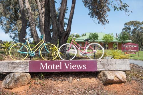 two bikes parked on a sign in front of a motel views at Motel Views Yackandandah in Yackandandah