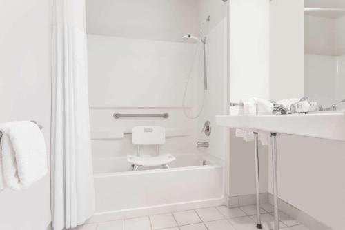 a bathroom with a sink, toilet and bathtub at Days Inn by Wyndham Ocean Shores in Ocean Shores
