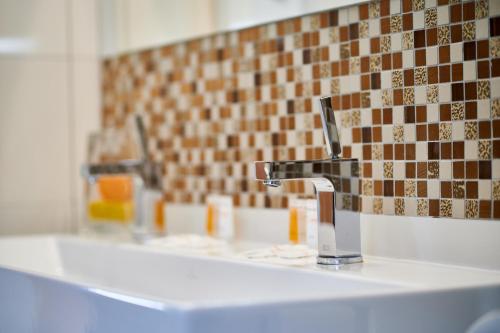 two sinks in a bathroom with two faucets at Heipark Tošovice in Tošovice