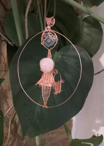 a necklace with a pink bead on a string at Safine B&B in Fåborg