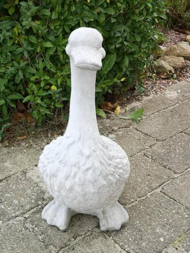 a white statue of a duck sitting on the ground at Safine B&B in Fåborg