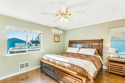 a bedroom with a bed with a ceiling fan and a window at Westport Marina View in Westport