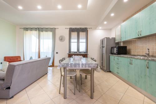 a kitchen with a table and a couch at Villa Sunset in Capitana