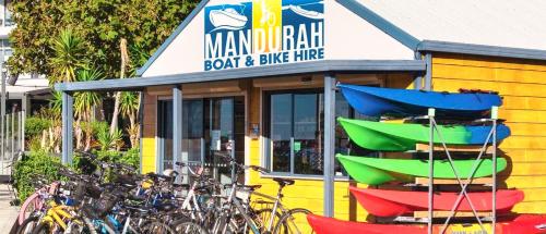 a group of bikes parked in front of a store at Marina Canals Apartment in Mandurah