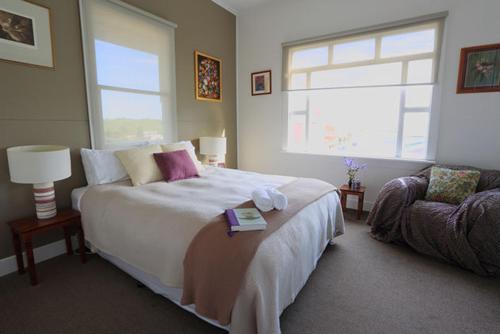 a bedroom with a large bed and a window at Sea Salt House in Stanley