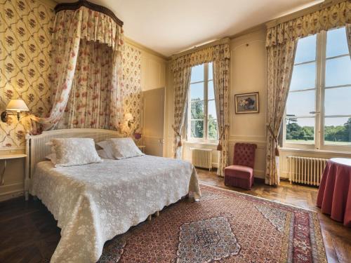a bedroom with a large bed and a large window at Château de Boucéel - Mont Saint Michel in Vergoncey