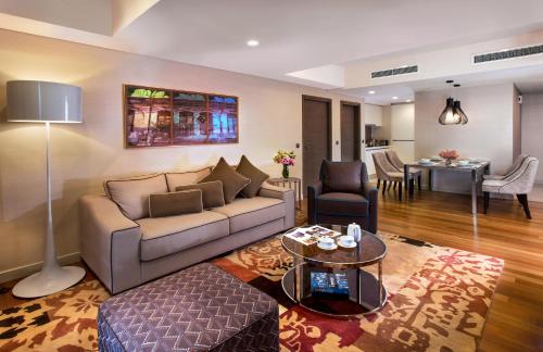 a living room with a couch and a table at Ascott Sentral Kuala Lumpur in Kuala Lumpur
