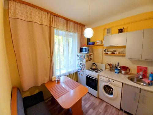 a small kitchen with a table and a sink at "В центре города" Квартира - "Downtown" Apartment in Almaty