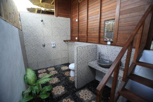 a bathroom with a toilet and a sink at Sunset Coin Lembongan in Nusa Lembongan
