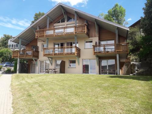 a house with a large yard in front of it at Les Adrets in Gérardmer