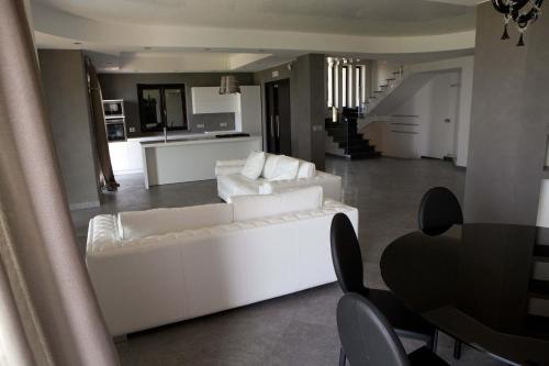 a living room with a white couch and a table at Villa Mediterraneo in Fuscaldo