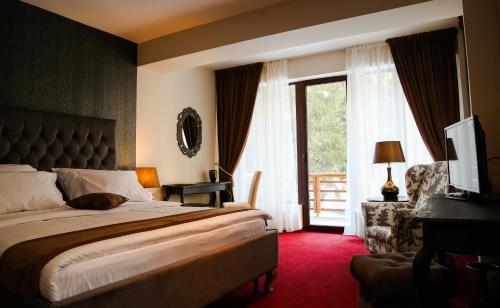 a hotel room with a bed and a window at Oblique - Forest & Spa in Sinaia