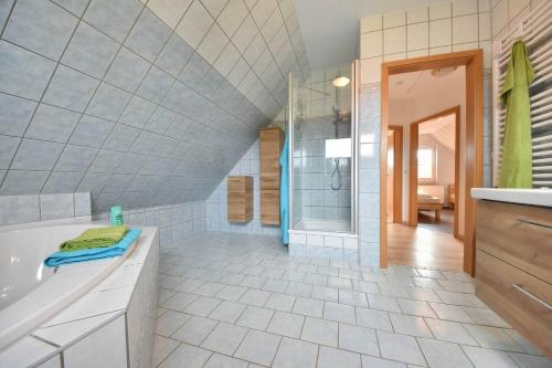 a large bathroom with a tub and a shower at Ferienhaus Inselnest in Pudagla