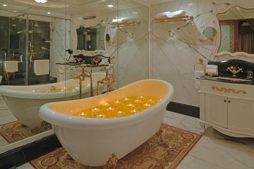 a large bathroom with a tub and a sink at Indana Palace, Jodhpur in Jodhpur