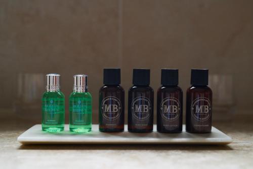 a group of four bottles of liquid on a tray at The Grand, York in York