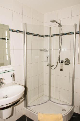 a bathroom with a shower and a sink at Gasthof Rose in Flachslanden