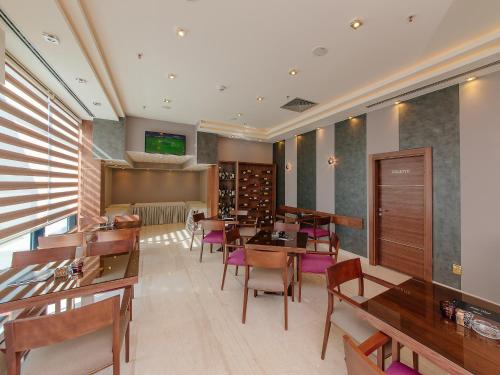 a dining room with wooden tables and chairs at Hotel New Star in Podgorica
