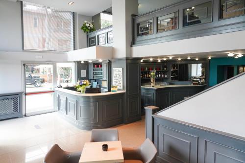 a kitchen with dark cabinets and a bar at Sole Mare in Ventimiglia