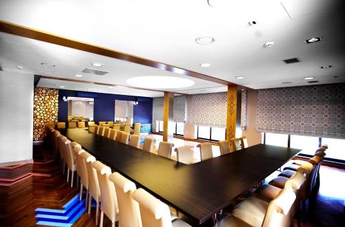 a large conference room with a long table and chairs at Hotel Piwniczna SPA&Conference in Piwniczna