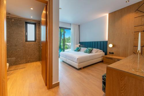 a bedroom with a bed and a walk in shower at Villa Lydia I Superb views, two pools, next to the city in Kissamos