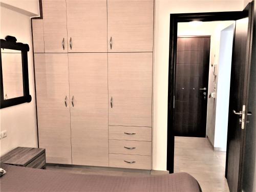 a bedroom with a large closet with wooden cabinets at Paradieso Apartement Agios Nikolaos in Agios Nikolaos